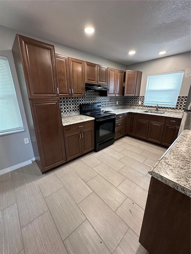 kitchen with backsplash, black range with electric cooktop, sink, and light tile floors