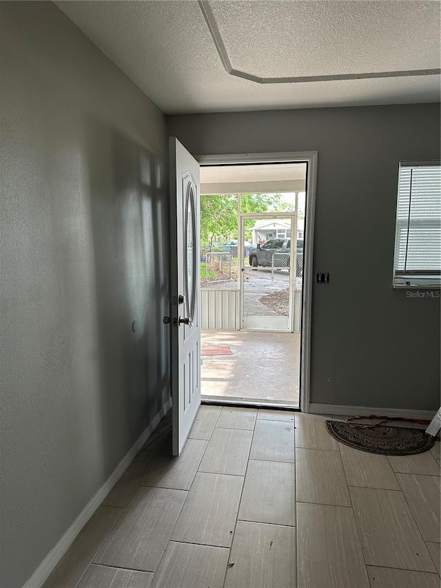 doorway featuring a textured ceiling