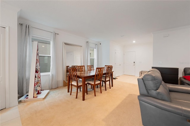 dining room featuring crown molding and light tile patterned floors