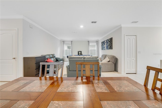 dining area featuring light hardwood / wood-style floors and crown molding