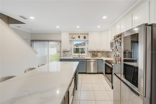 kitchen featuring white cabinets, sink, gray cabinetry, and stainless steel appliances