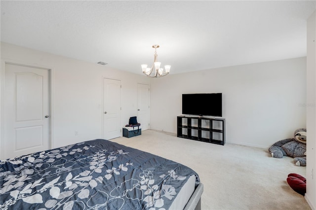 bedroom with carpet flooring and an inviting chandelier