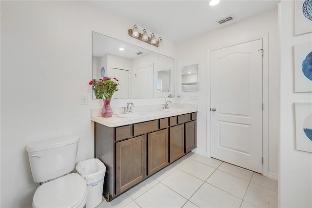 bathroom featuring tile patterned flooring, vanity, and toilet