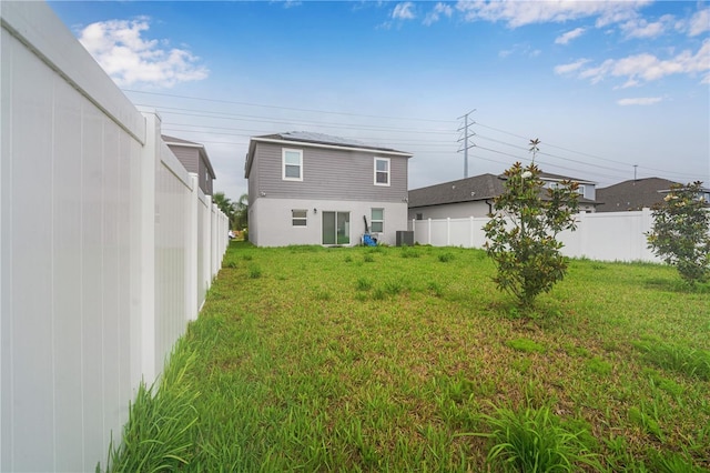 rear view of house featuring a yard