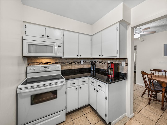 kitchen featuring white appliances, white cabinets, backsplash, light tile flooring, and ceiling fan