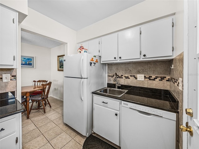 kitchen with white cabinets, sink, white appliances, and tasteful backsplash