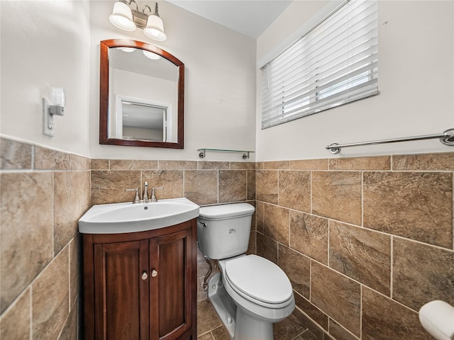 bathroom featuring tile walls, backsplash, toilet, tile flooring, and vanity