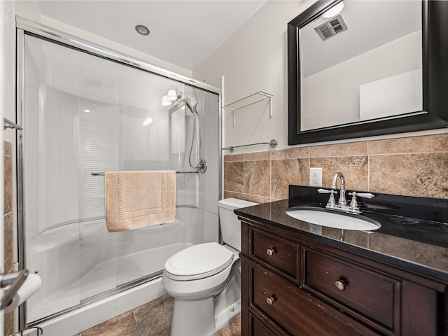 bathroom featuring backsplash, toilet, tile floors, an enclosed shower, and vanity