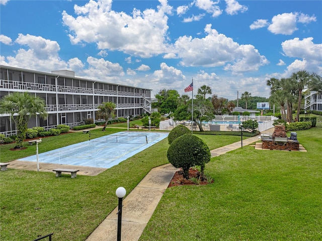 view of pool with a yard