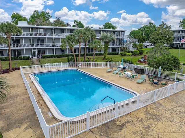 view of pool featuring a yard and a patio area