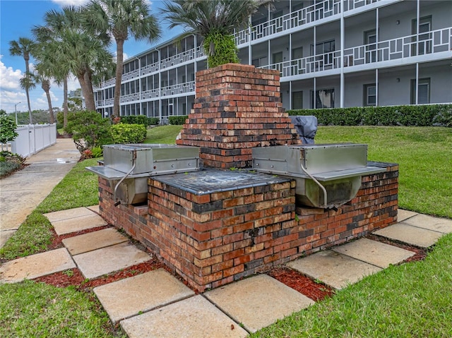 view of patio / terrace featuring an outdoor kitchen and a balcony