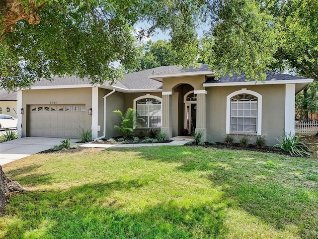 ranch-style home with a garage and a front yard