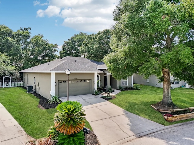 view of front of home with cooling unit, a front yard, and a garage