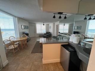 kitchen featuring light tile floors and kitchen peninsula