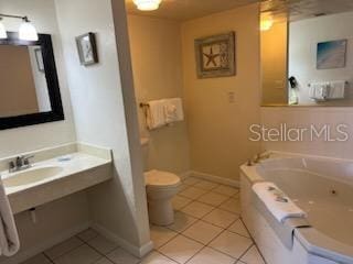 bathroom featuring a bath, tile floors, sink, and toilet