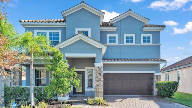 mediterranean / spanish-style home featuring a garage