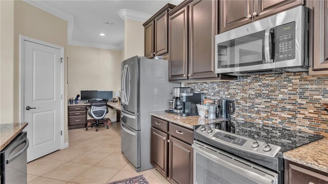 kitchen featuring backsplash, stainless steel appliances, dark brown cabinets, and light stone countertops