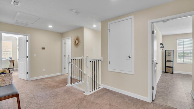 hall with light tile patterned floors