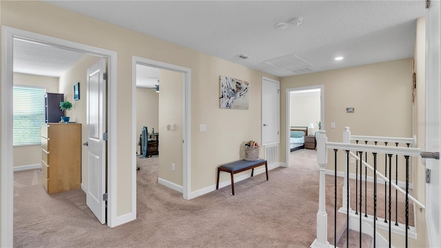 hallway featuring light colored carpet