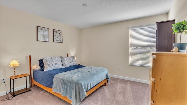 bedroom with multiple windows and light carpet