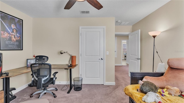 office space featuring ceiling fan and carpet