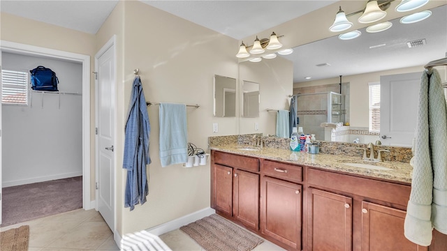 bathroom with tile patterned flooring, double vanity, and a shower with shower door