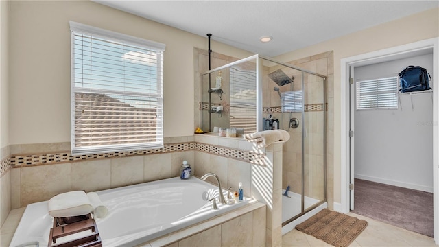 bathroom with a wealth of natural light, plus walk in shower, and tile patterned floors