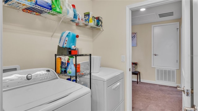 clothes washing area featuring carpet floors and washing machine and clothes dryer