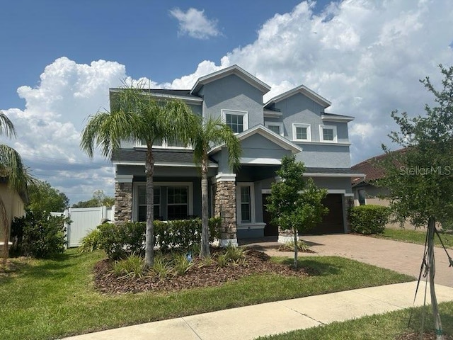 11928 Frost Aster Dr, Riverview, FL 33579 - view of front of house featuring stone siding, stucco siding, decorative driveway, and an attached garage