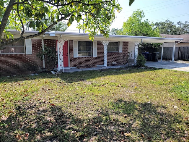 single story home with a front lawn and a carport