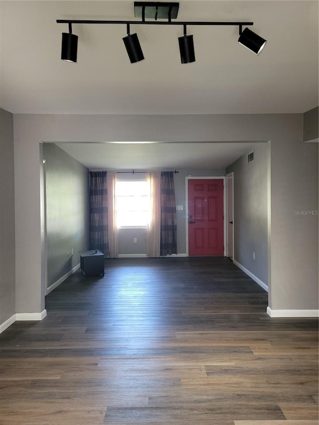 empty room featuring dark wood-type flooring