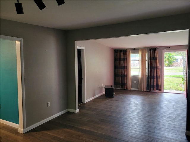 unfurnished room with ceiling fan and dark hardwood / wood-style floors