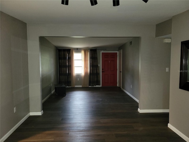 spare room featuring dark hardwood / wood-style flooring and ceiling fan