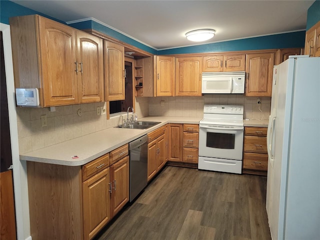 kitchen featuring sink, white appliances, dark hardwood / wood-style floors, and tasteful backsplash