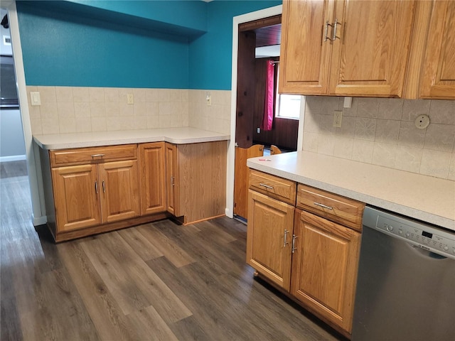 kitchen with dark hardwood / wood-style floors, backsplash, and stainless steel dishwasher