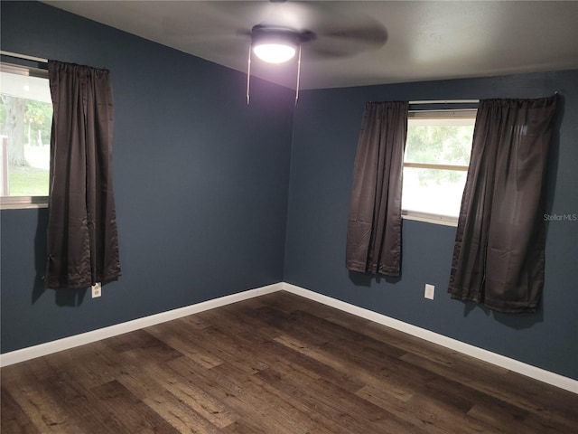 empty room featuring dark hardwood / wood-style floors and ceiling fan