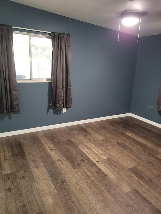 unfurnished room with dark hardwood / wood-style floors