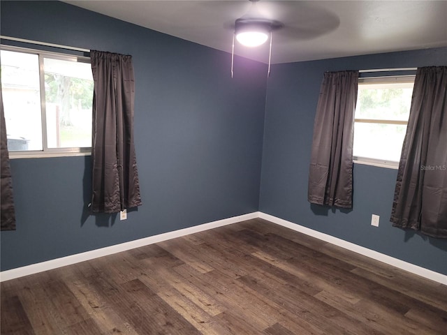 unfurnished room with dark wood-type flooring and ceiling fan