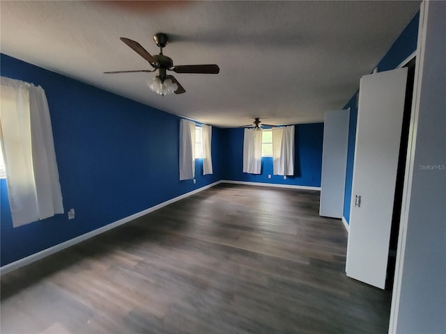 unfurnished room with dark hardwood / wood-style floors and ceiling fan