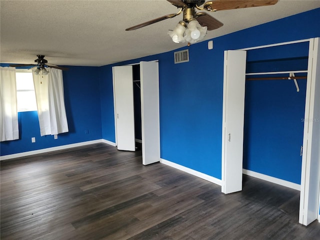 unfurnished bedroom featuring a textured ceiling, dark wood-type flooring, and ceiling fan