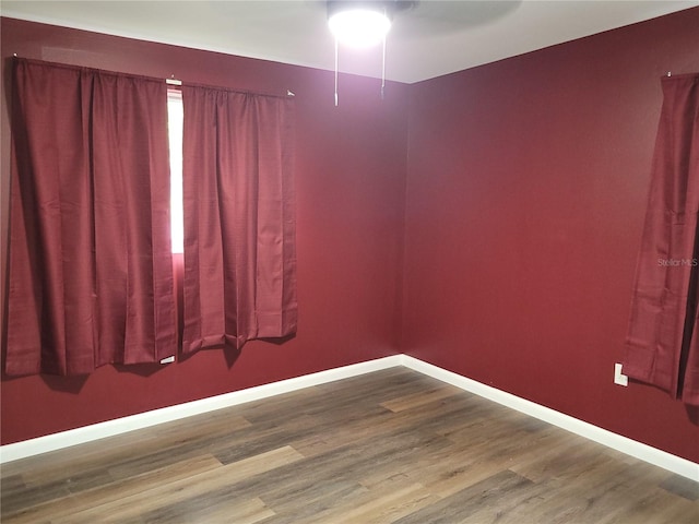 empty room featuring wood-type flooring and ceiling fan