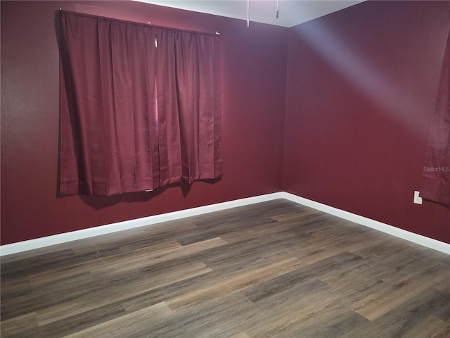 empty room featuring dark wood-type flooring