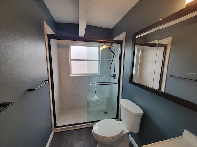 bathroom with walk in shower, toilet, and wood-type flooring