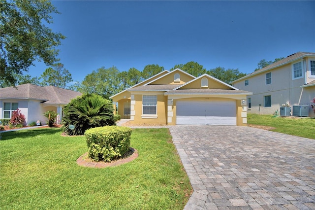 view of front of home with a garage, a front lawn, and cooling unit