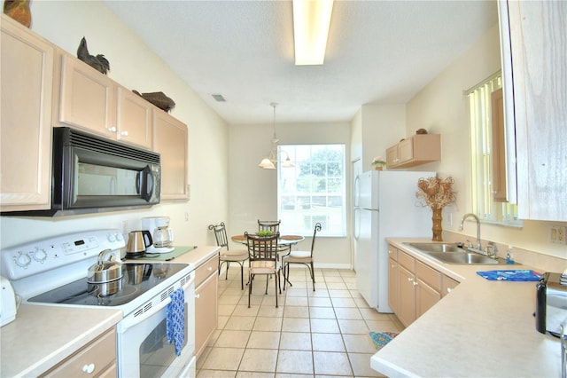 kitchen with electric range, sink, decorative light fixtures, light brown cabinetry, and light tile patterned floors