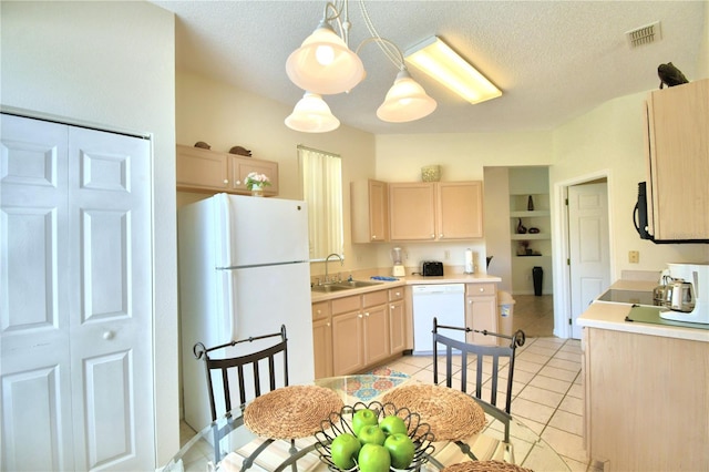 kitchen with sink, pendant lighting, a textured ceiling, white appliances, and light brown cabinetry