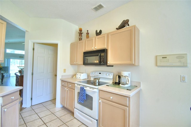 kitchen featuring white range with electric cooktop, lofted ceiling, a textured ceiling, light brown cabinetry, and light tile patterned flooring