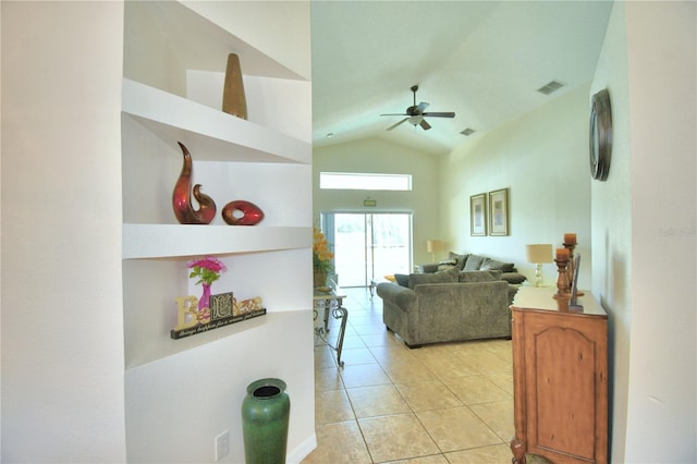 living room featuring ceiling fan, light tile patterned floors, and lofted ceiling