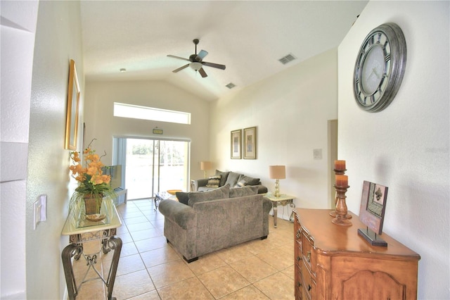 living room with ceiling fan, light tile patterned floors, and vaulted ceiling