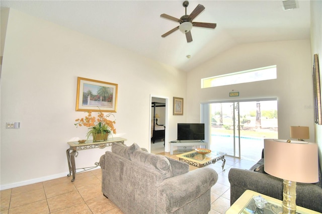 living room featuring ceiling fan, light tile patterned floors, and vaulted ceiling